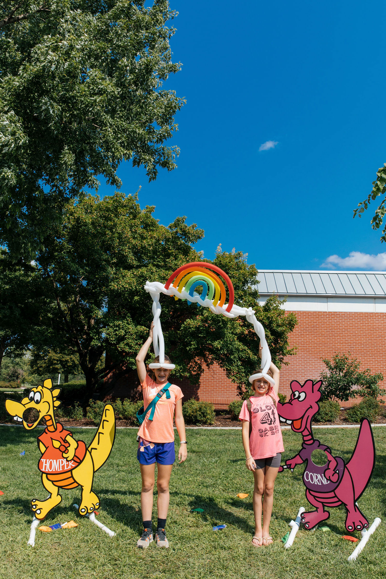 Emma Ingleman and Hannah Stromer show off their balloon hats during Kool-Aid Days in Hastings, Nebraska.