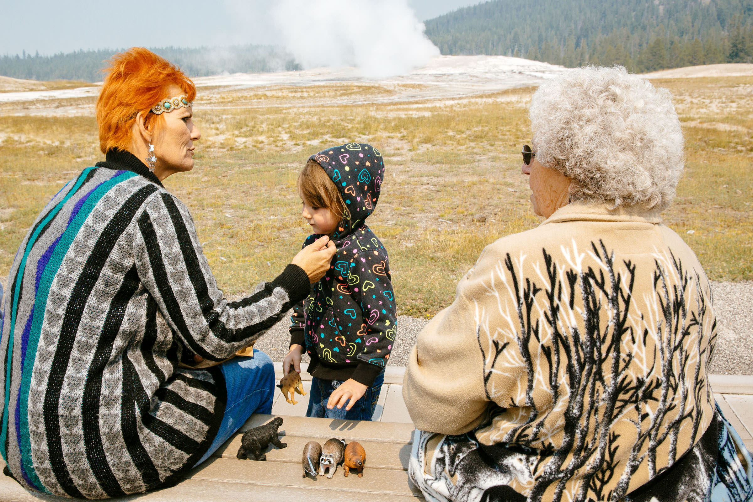 Tourists at Old Faithful Geyser, Yellowstone National Park.